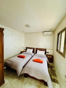 two beds in a room with two beds sidx sidx sidx at The Sun Gate in Agadir +11 photos