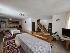 a living room with two beds and a staircase at Casa Cerbu in Arieşeni