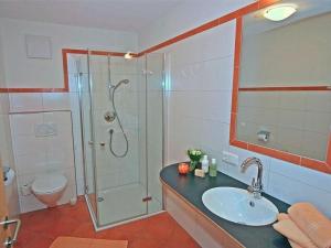 a bathroom with a shower and a sink and a toilet at Apartment Künzel by Interhome in Schröcken