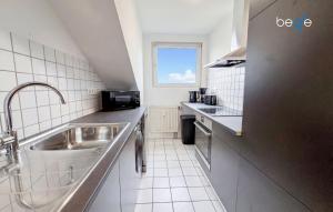 a kitchen with a sink and a counter top at BEGE APARTMENTS FlowLoft in Wegberg