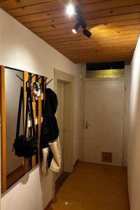 a room with a ceiling fan and a hallway with skis at Apartment Thun Relax Suite by Interhome in Thun