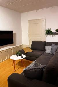 a living room with a couch and a table at Apartment Thun Relax Suite by Interhome in Thun