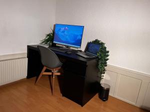 a desk with a computer and a laptop on it at Apartment Thun Relax Suite by Interhome in Thun