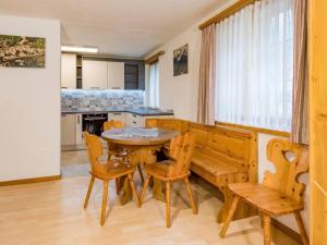 a dining room with a wooden table and chairs at Apartment Wohnung Muntegn by Interhome in Vicosoprano