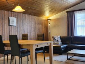a living room with a table and a couch at Apartment Tgèsa Val by Interhome in Sedrun