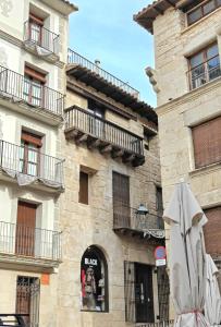 a building with balconies on the side of it at Casa riera in Valderrobres