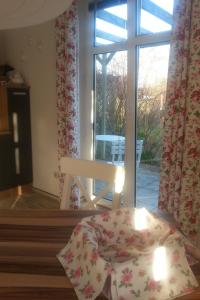 a room with a window with a table and a bench at Apartment Florö by Interhome in Putbus