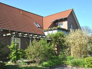 a brick house with a balcony with flowers on it at Apartment Florö by Interhome in Putbus