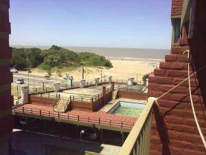 a balcony with a swimming pool and a beach at SAN CLEMENTE RIAZOr 6 in San Clemente del Tuyú