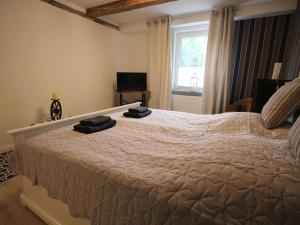 a bedroom with a bed with two towels on it at Holiday Home Weideblick by Interhome in Geestland