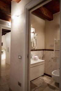 a bathroom with a sink and a toilet at Piccola Venezia Room in Chioggia