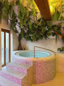 a jacuzzi tub in a room with plants at Hotel Chateau Orlice in Letohrad +26 photos