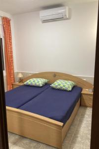 a bedroom with a bed with two pillows on it at Holiday Home Casa Blumer by Interhome in Les tres Cales