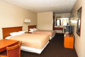 a hotel room with two beds and a desk at Hotel Deerfield Inn & Suites Acworth Atlanta in Acworth