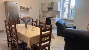 a kitchen and dining room with a table and chairs at La Casa del Torrente in Rieti +20 photos