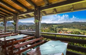a patio with tables and chairs and a view of the mountains at Guesthouse Pavlin in Samobor