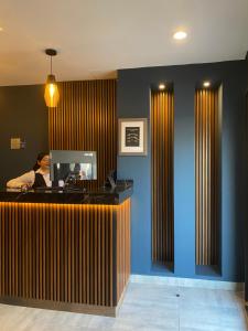 a woman sitting at a counter in a office at Best Western Real Tula Express in Tula de Allende