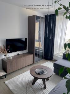 a living room with a tv and a coffee table at Stobrawa premium 2 in Kluczbork