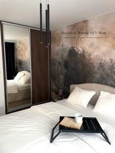 a bedroom with a bed with a table on it at Stobrawa premium 2 in Kluczbork