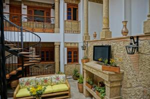 a living room with a couch and a tv on a building at Hotel Campanario Real in Villa de Leyva