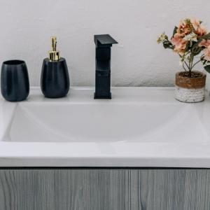 a white sink with two vases and flowers on it at La Grande in Benoni +44 photos