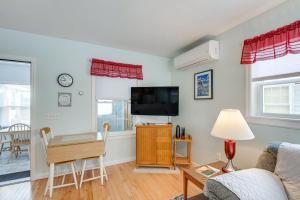 a living room with a couch and a table and a tv at Unbeatable Downtown Location! Bar Harbor Apt in Bar Harbor