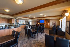 a restaurant with tables and chairs and a bar at Canalta Hotel Provost in Provost
