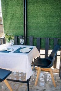 a table with two chairs and a white table cloth at La Grande in Benoni