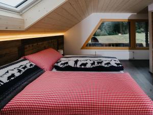 two beds in a room with a window at Apartment Hof Obertalgut by Interhome in Teuffenthal