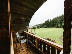 a room with a balcony with a view of a field at Apartment Hof Obertalgut by Interhome in Teuffenthal