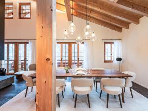 a dining room with a wooden table and chairs at Chalet Chalet Andra by Interhome in Grindelwald