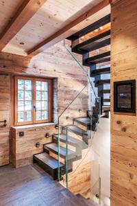 a staircase in a wooden house with wooden walls at Chalet Chalet Andra by Interhome in Grindelwald +34 photos