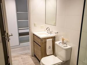 a bathroom with a toilet and a sink at Cañada Suites by FMA Coliving in Salta +10 photos