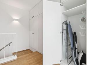 a room with white cabinets and a staircase at Apartment Loft Seven by Interhome in Root