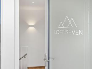 a sliding glass door with a lot seven sign on it at Apartment Loft Seven by Interhome in Root