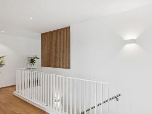 a white staircase with two lights on the wall at Apartment Loft Seven by Interhome in Root