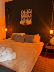 a bedroom with a bed with two towels on it at The Nest, Apartament in Oświęcim