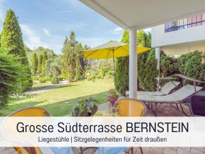 a patio with a table and an umbrella at Apartment BERNSTEIN by Interhome in Wertach