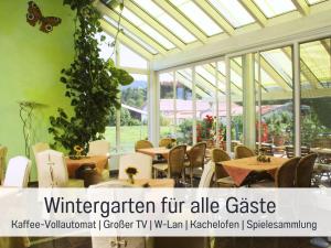 a restaurant with tables and chairs in a conservatory at Apartment BERNSTEIN by Interhome in Wertach