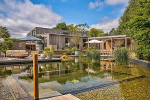 a house with a pond in front of it at Olive Orchard in Cropredy