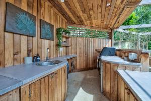 a kitchen with a sink and a wooden wall at Olive Orchard in Cropredy +39 photos