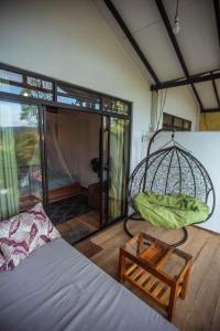 a bedroom with a bed and a swing at Slon Ella in Ella +28 photos