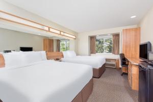 a hotel room with two beds and a television at Knights Inn Allentown in Allentown +11 photos