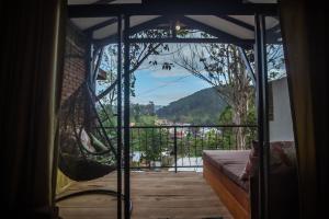 a view from a room with a hammock on a balcony at Slon Ella in Ella