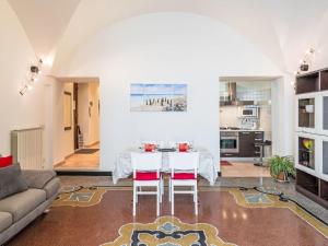 a living room with a table and two chairs at Apartment Emanuela by Interhome in Alassio