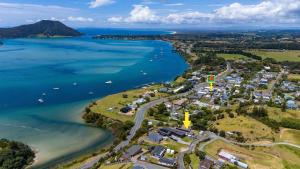 an aerial view of the shoreline of a lake at Hook'em Heights in Pukenui +1 photo