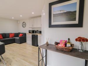 a living room with a couch and a table at Binevenagh Point Cabin in Limavady +10 photos