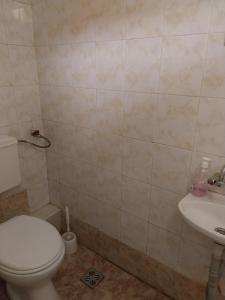 a bathroom with a toilet and a sink at Скай Румс -2 in Sofia