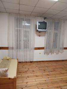 a room with a bed and a tv on the wall at Скай Румс -2 in Sofia