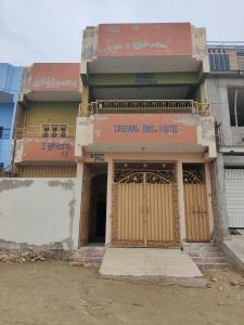 a building with wooden doors in a city at Dream Hostel Sukkur in Sukkur